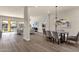 Open-concept living and dining area with wood floors and view of backyard pool at 17002 S 178Th Ave, Goodyear, AZ 85338