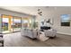 Living room with view of backyard pond and patio seating at 17002 S 178Th Ave, Goodyear, AZ 85338