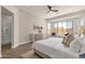 Spacious main bedroom with wood-look floors, a ceiling fan, sitting area, and a serene atmosphere at 17002 S 178Th Ave, Goodyear, AZ 85338