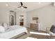 Inviting main bedroom with wood-look floors, ceiling fan, leading to the en-suite bathroom at 17002 S 178Th Ave, Goodyear, AZ 85338