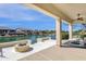 Covered patio provides beautiful waterway views and outdoor seating next to a fire pit at 17002 S 178Th Ave, Goodyear, AZ 85338