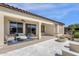 Inviting outdoor patio with ample seating areas, a fire pit, and sliding glass door entrances at 17002 S 178Th Ave, Goodyear, AZ 85338