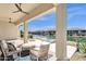 Covered patio featuring water views, a fire pit, and an outdoor seating area at 17002 S 178Th Ave, Goodyear, AZ 85338