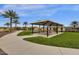 Shaded picnic area with tables and lush green grass, perfect for outdoor gatherings at 17002 S 178Th Ave, Goodyear, AZ 85338