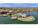 Beautiful community pool and lake with lounging area and desert landscape at 17002 S 178Th Ave, Goodyear, AZ 85338