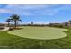 Beautifully landscaped putting green with mature trees and manicured lawns in a welcoming community at 17002 S 178Th Ave, Goodyear, AZ 85338