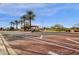 Inviting community entrance with palm trees, well-maintained streets, and a welcoming atmosphere at 17002 S 178Th Ave, Goodyear, AZ 85338