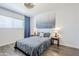 Cozy bedroom featuring wood floors, a queen bed, and an eye-catching modern ceiling fan at 17241 N 16Th Dr # 1, Phoenix, AZ 85023