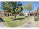 Well-maintained condominium community featuring lush green lawns and mature trees under a clear blue sky at 17241 N 16Th Dr # 1, Phoenix, AZ 85023