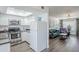 Modern kitchen with stainless steel appliances, white cabinetry, granite countertops, and seamless flow to the living room at 17241 N 16Th Dr # 1, Phoenix, AZ 85023