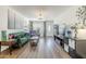 Spacious living room with hardwood floors, a comfortable green sofa, and abundant natural light at 17241 N 16Th Dr # 1, Phoenix, AZ 85023