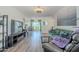 Inviting living room featuring hardwood floors, a plush green sofa, and serene decor with a dining room in the background at 17241 N 16Th Dr # 1, Phoenix, AZ 85023