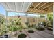Charming covered patio with outdoor seating surrounded by lush plants and privacy walls at 17241 N 16Th Dr # 1, Phoenix, AZ 85023