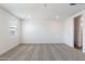 An empty bedroom with neutral carpet and a window at 17808 W Sanna St, Waddell, AZ 85355