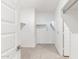 A bright walk-in closet with carpet flooring and shelves at 17808 W Sanna St, Waddell, AZ 85355