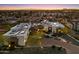 Aerial view of a luxury home with solar panels and a landscaped front yard at sunset at 18116 N 14Th St, Phoenix, AZ 85022