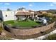 Expansive backyard with artificial grass, a stone wall, and outdoor pool area at 18116 N 14Th St, Phoenix, AZ 85022