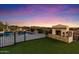 Resort-style backyard featuring a pool, stone fireplace and mountain views at 18116 N 14Th St, Phoenix, AZ 85022