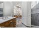 Large bathroom features dual vanities, walk in shower and marble floors at 18116 N 14Th St, Phoenix, AZ 85022