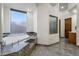 Bathroom boasting a soaking tub with decorative tile surround and privacy window at 18116 N 14Th St, Phoenix, AZ 85022