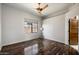 Bedroom features wood flooring, a ceiling fan and a window with privacy blind at 18116 N 14Th St, Phoenix, AZ 85022