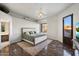 Bright bedroom with king bed, wood floors, ceiling fan and natural light at 18116 N 14Th St, Phoenix, AZ 85022