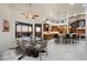 Bright dining room with a glass table, modern chairs, and an adjacent kitchen at 18116 N 14Th St, Phoenix, AZ 85022