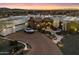 Beautiful front exterior view of a luxury home with a circular driveway, desert landscaping, and mountain views at 18116 N 14Th St, Phoenix, AZ 85022