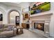 Comfortable living room showcasing a fireplace, wet bar and stone archway at 18116 N 14Th St, Phoenix, AZ 85022