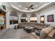 Open living room featuring large windows, neutral tones, and a comfortable sectional couch at 18116 N 14Th St, Phoenix, AZ 85022