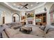 Living room with a stone fireplace, built-in entertainment center, and a large sectional couch at 18116 N 14Th St, Phoenix, AZ 85022