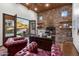 Home office with a stone accent wall, built-in shelves, and french doors to backyard at 18116 N 14Th St, Phoenix, AZ 85022