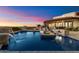 Backyard pool features a waterfall and outdoor dining area, creating a perfect space for entertaining and relaxation at 18116 N 14Th St, Phoenix, AZ 85022