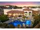 Aerial view of a luxurious backyard with a sparkling pool, patio, and lush landscaping at 18116 N 14Th St, Phoenix, AZ 85022