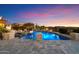 Backyard pool with stone accents, a basketball hoop, and mountain views at 18116 N 14Th St, Phoenix, AZ 85022