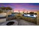 Backyard pool features a fire pit and seating area, perfect for relaxing and enjoying the outdoors at 18116 N 14Th St, Phoenix, AZ 85022
