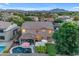 Aerial view of large home showcasing the backyard with pool, patio, putting green, and seating areas at 18460 E Peachtree Blvd, Queen Creek, AZ 85142