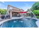 Large backyard features a sparkling pool with water features, patio, and putting green at 18460 E Peachtree Blvd, Queen Creek, AZ 85142