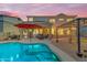 Relaxing backyard oasis features pool, lounging area, barbecue, and mature trees at 18460 E Peachtree Blvd, Queen Creek, AZ 85142