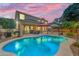 Relaxing backyard oasis features pool, lounging area, barbecue, and mature trees at 18460 E Peachtree Blvd, Queen Creek, AZ 85142
