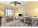 Bright bedroom designed as an office space, featuring ample natural light, and ample storage for a productive workspace at 18460 E Peachtree Blvd, Queen Creek, AZ 85142