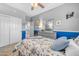 Well-lit bedroom showcasing a queen-size bed, dresser with mirror, and access to a full bathroom at 18460 E Peachtree Blvd, Queen Creek, AZ 85142