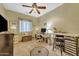 Neutral bedroom featuring natural light, ceiling fan, and desk, offering comfortable workspace at 18460 E Peachtree Blvd, Queen Creek, AZ 85142