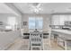 Bright dining area showcasing a wood table with six chairs, connecting to the kitchen counter with barstool seating at 18460 E Peachtree Blvd, Queen Creek, AZ 85142