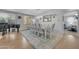Elegant dining room with a large table, stylish chandelier, and beautiful hardwood floors at 18460 E Peachtree Blvd, Queen Creek, AZ 85142
