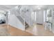 Bright entryway featuring a staircase, neutral tones, decorative accents, and hardwood flooring creating a welcoming ambiance at 18460 E Peachtree Blvd, Queen Creek, AZ 85142