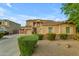 Beautiful two-story home with a three-car garage, desert landscaping, and a manicured front yard at 18460 E Peachtree Blvd, Queen Creek, AZ 85142