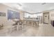 Modern kitchen with stainless appliances, white cabinets, eat-in dining table and large center island at 18460 E Peachtree Blvd, Queen Creek, AZ 85142