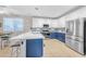 Bright, open kitchen featuring stainless steel appliances, a center island, and a casual dining area at 18460 E Peachtree Blvd, Queen Creek, AZ 85142