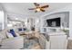 Inviting living room with comfortable white leather seating and a large TV for entertainment at 18460 E Peachtree Blvd, Queen Creek, AZ 85142